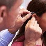 woman being fitted with a hearing aid