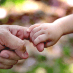 CloseUpOfManAndChildHoldingHands_GettyImages_250x250