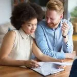 Couple signing mortgage papers