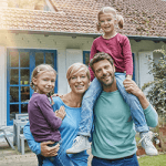 happy-family-in-front-of-their-house_GettyImages_250x250
