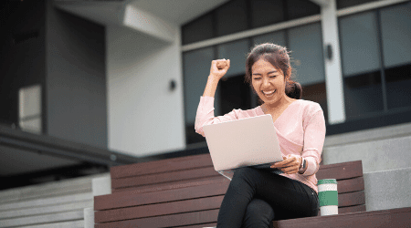 Image of a happy woman on her laptop