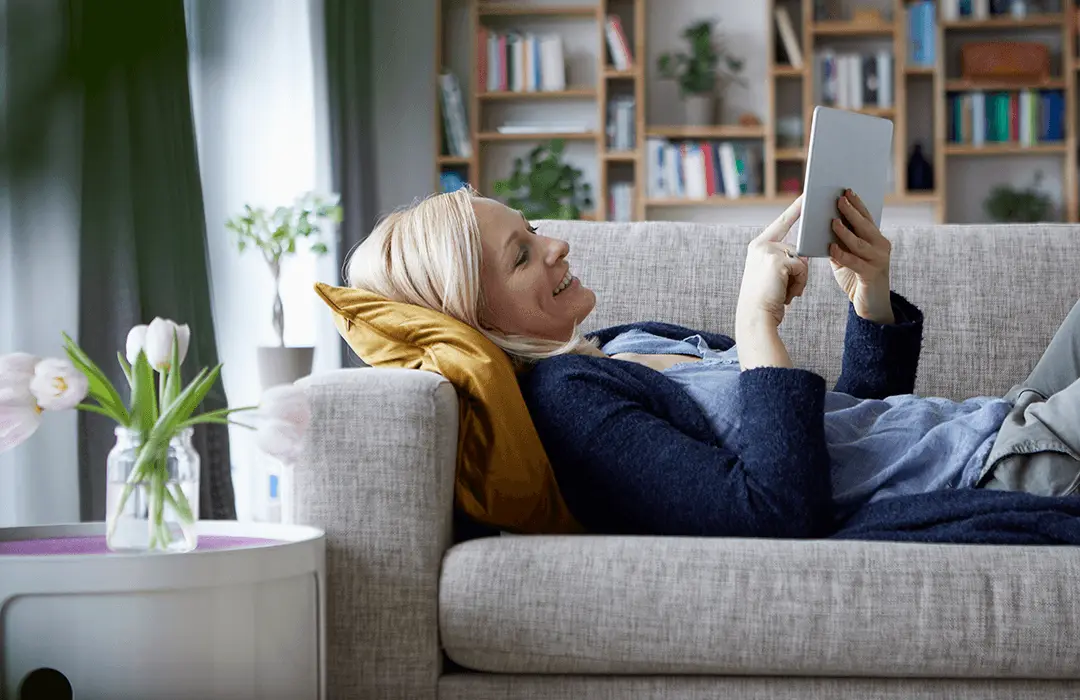 Lady using tablet on sofa