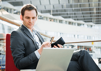 Businessman using a credit card in an airport lounge