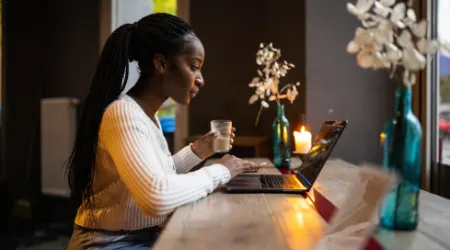 Woman working on laptop at coffee shop