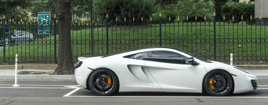 White luxury sports car on a neighborhood street