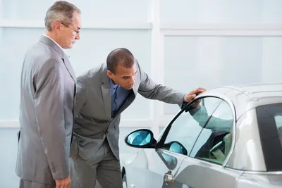 Two men inspecting a vehicle Image: skynesher/Getty Images