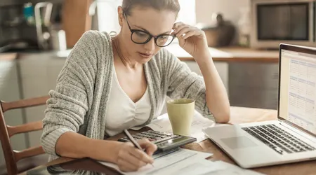 Woman working though her finances to save money