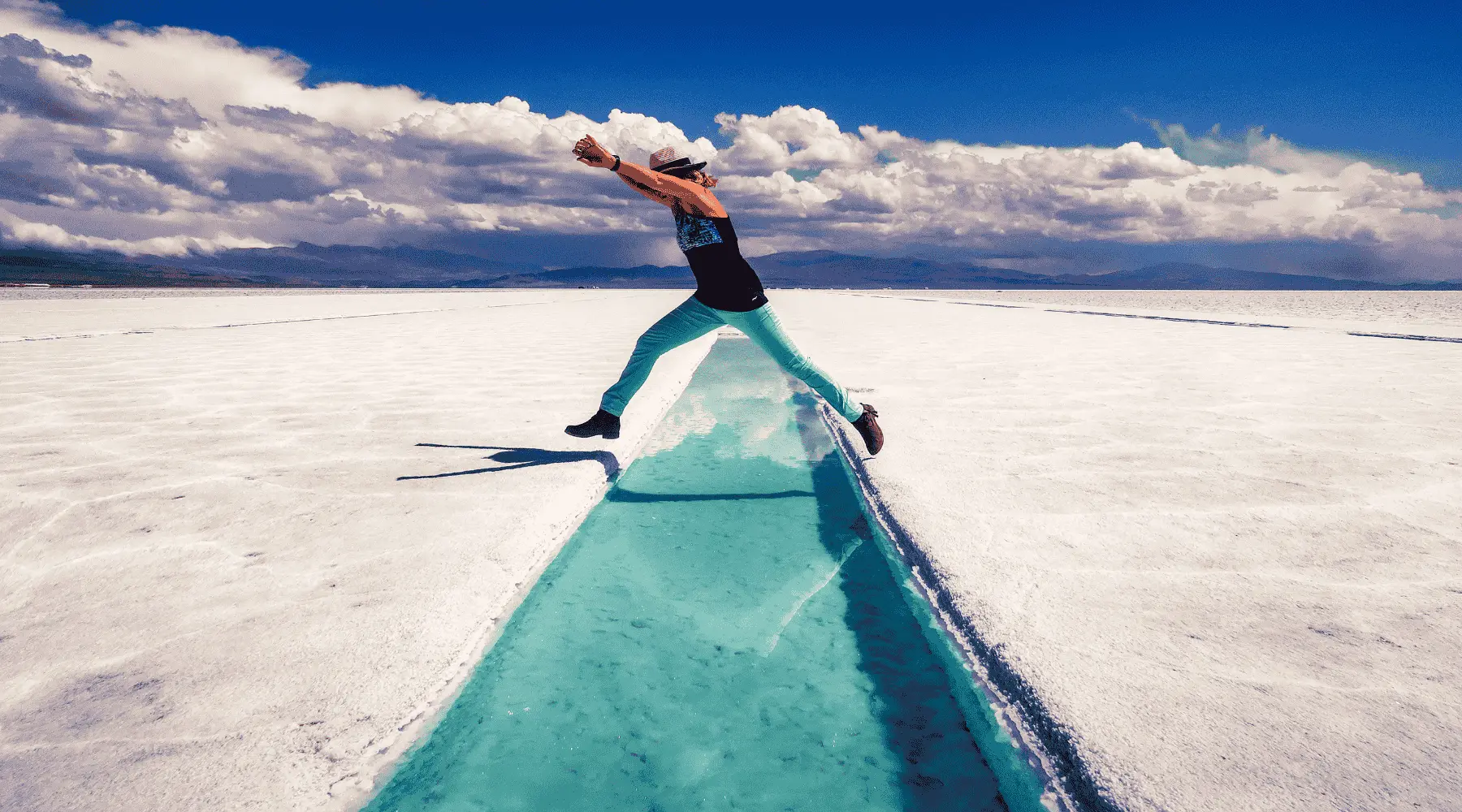 Woman jumping over water