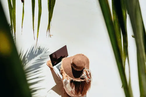 Woman on laptop at beach